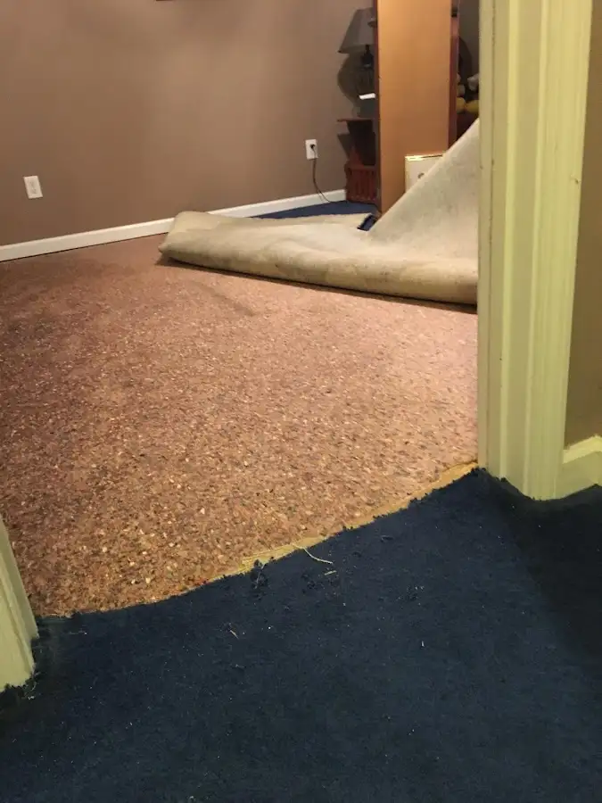 Carpet pad removal revealing water damage during Water Mitigation Services in El Paso